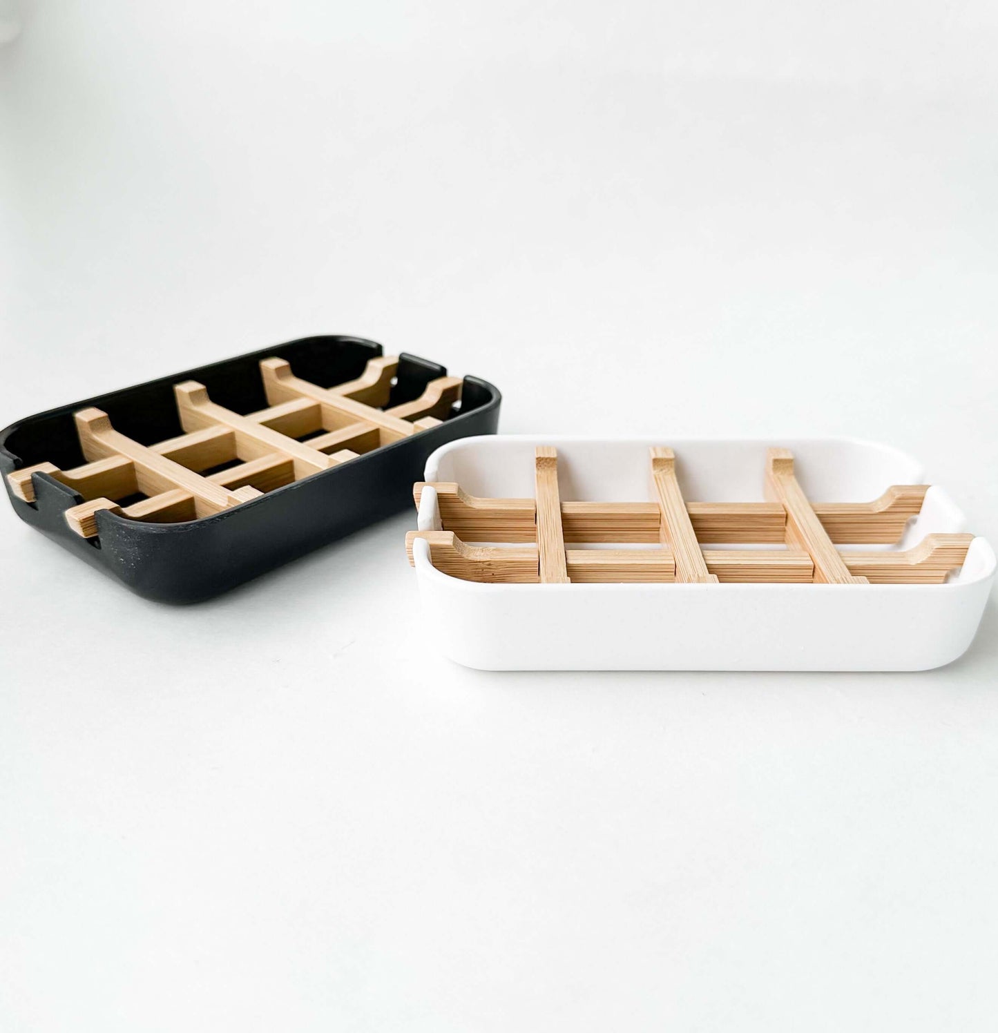 Biodegradable bamboo and cornstarch soap dishes in black and white, eco-friendly and plastic-free design for zero waste.
