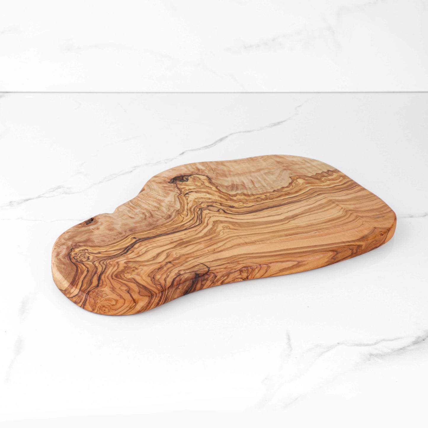 Handmade rustic olive wood cutting board with unique natural edges, perfect for kitchens and meal preparation.