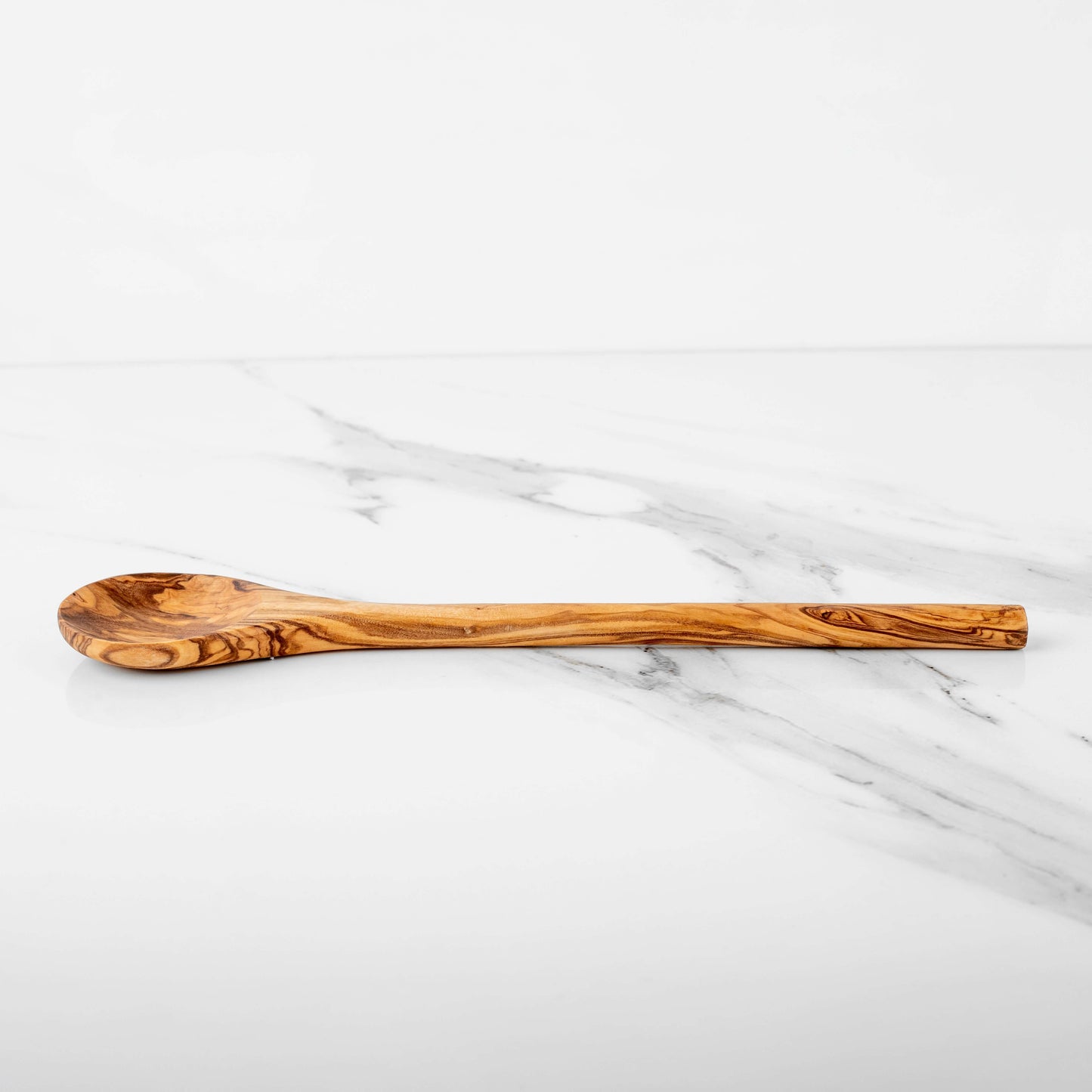 Handmade olive wood stirring spoon on a marble surface, 11.8 inches, eco-friendly and durable kitchen utensil.