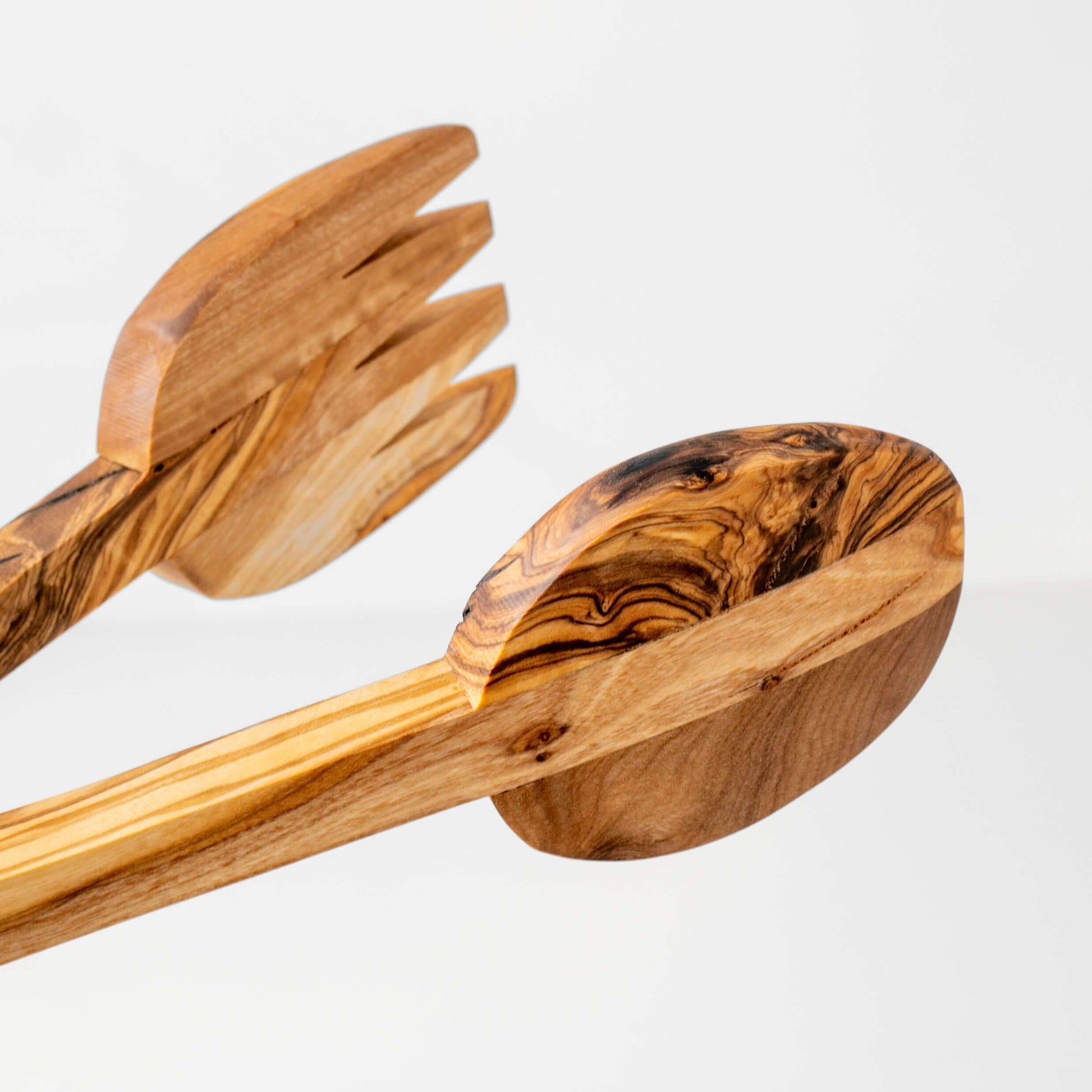 Handmade olive wood salad tongs with smooth handles, eco-friendly serving utensils for elegant dining.