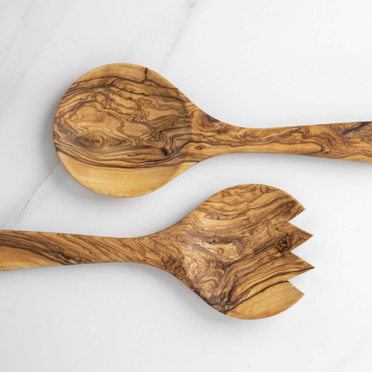 Handmade olive wood salad serving set featuring a spoon and fork with unique grain patterns.