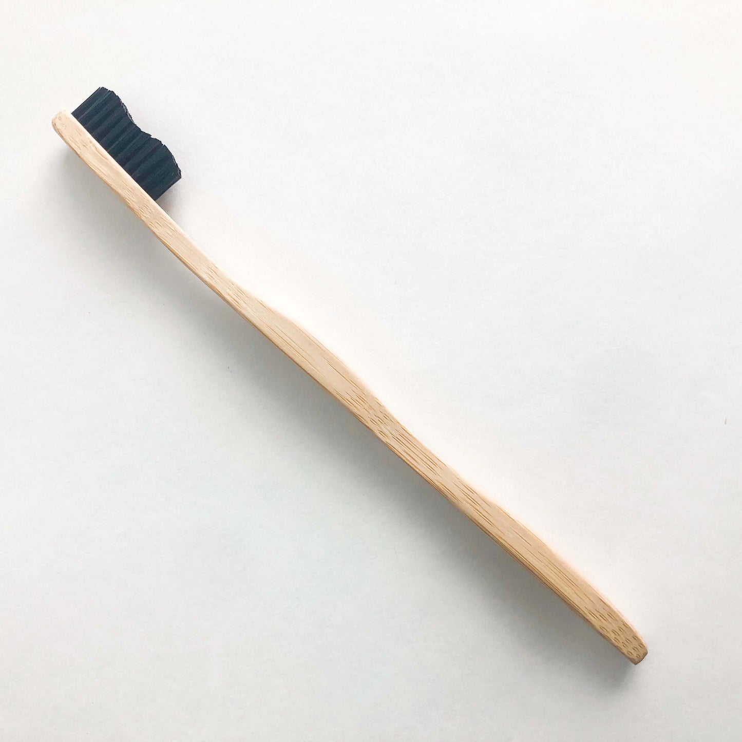 Eco-friendly bamboo toothbrush with activated charcoal bristles for a brighter smile and reduced plastic waste.