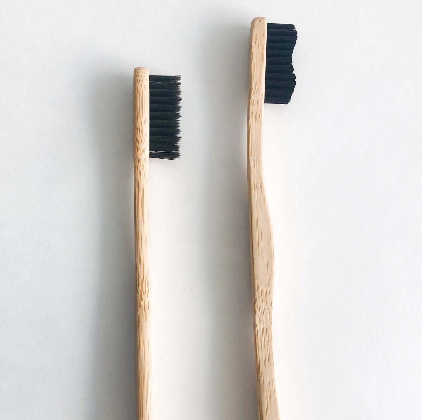 Eco-friendly bamboo toothbrushes with activated charcoal bristles for a bright smile and reduced plastic waste.