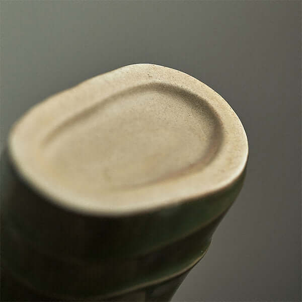 Top view of a ceramic cup showcasing its smooth rim and elegant bamboo green finish, perfect for tea or utensils.