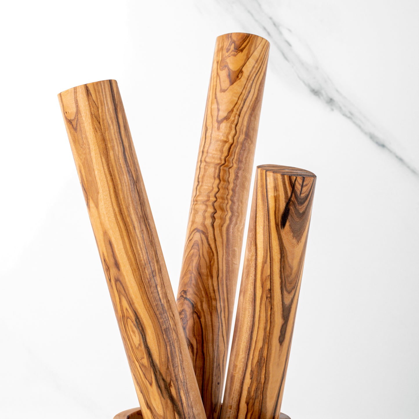 Handcrafted olive wood rolling pins in various sizes, showcasing elegant design for baking enthusiasts.