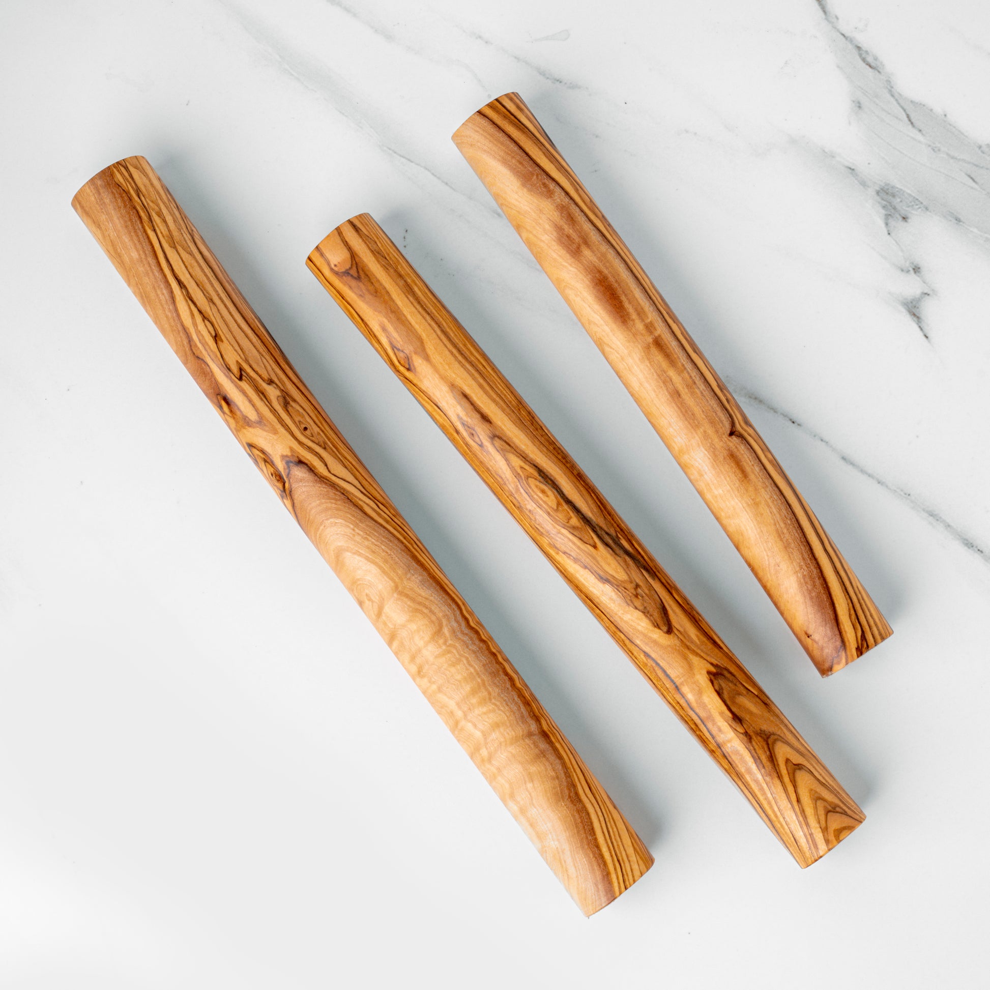 Handcrafted olive wood rolling pins in three sizes, perfect for effortless dough rolling for baking.