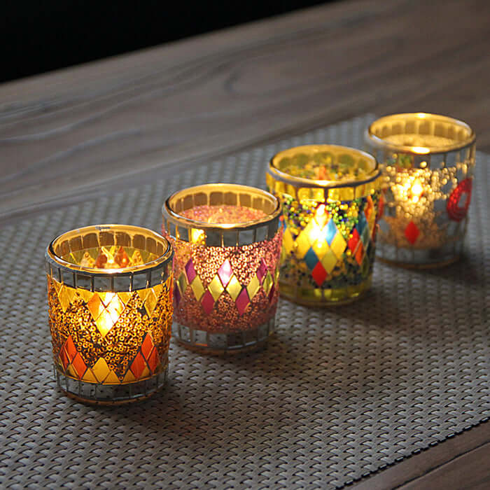 Colorful handmade glass candle holders shining with tealight candles, perfect for home decor and gifting.