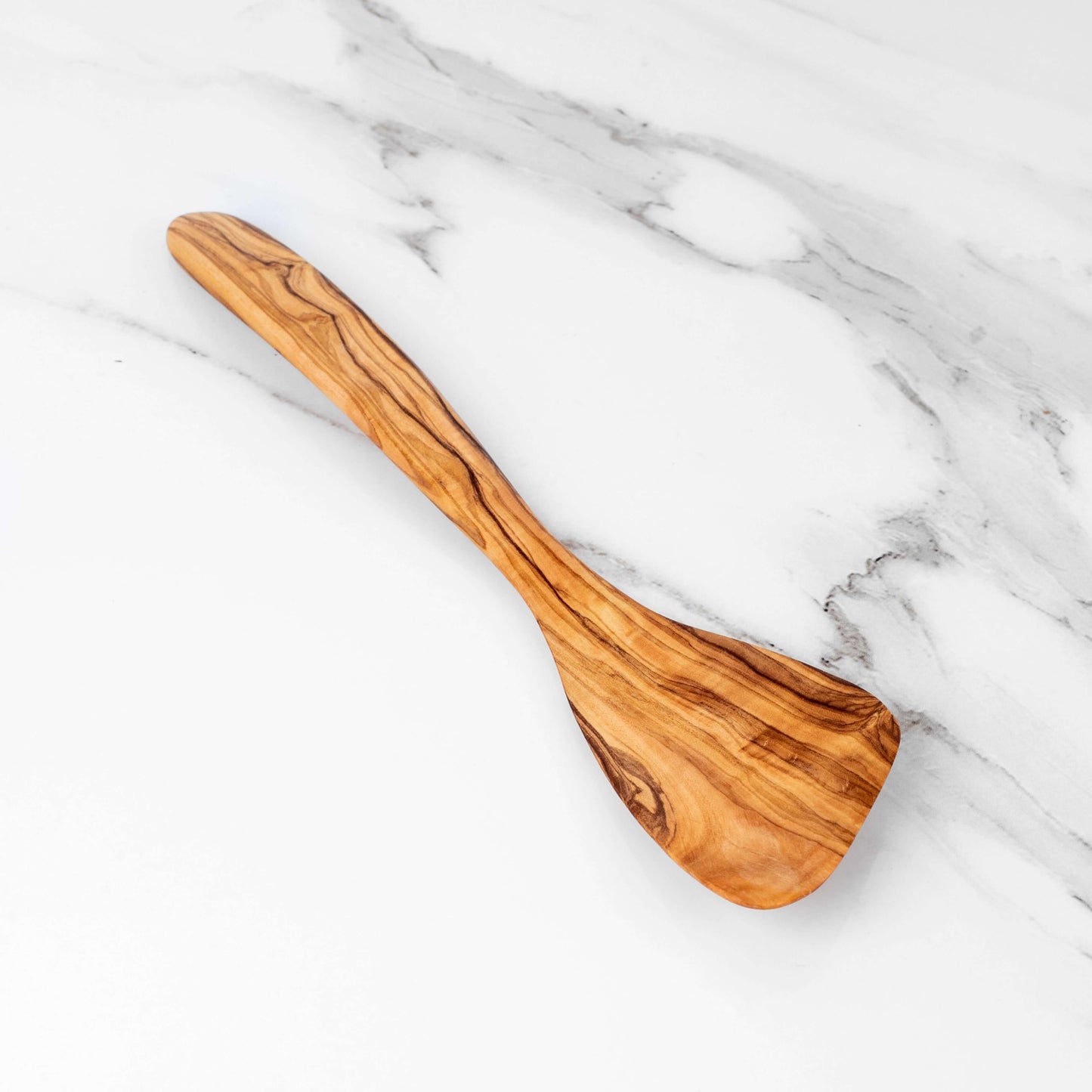 Handmade olive wood corner spatula on marble surface, 30cm for precise cooking and easy handling.