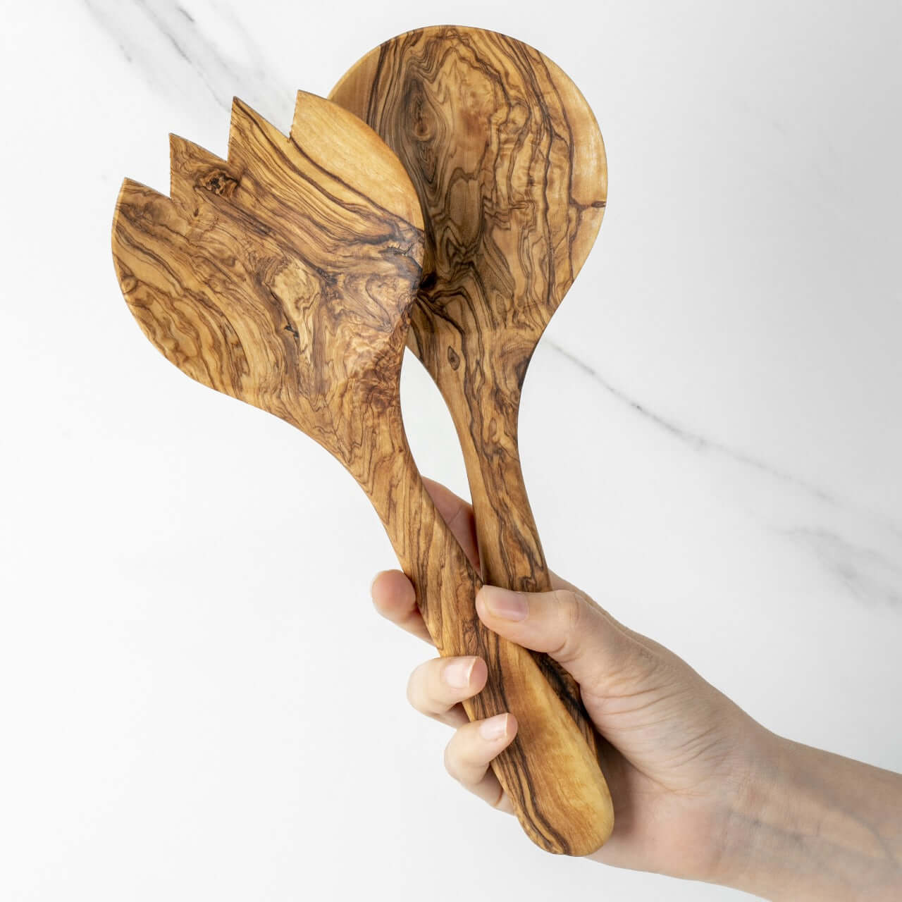 Handmade olive wood salad serving set featuring a fork and spoon, showcasing unique grain patterns.