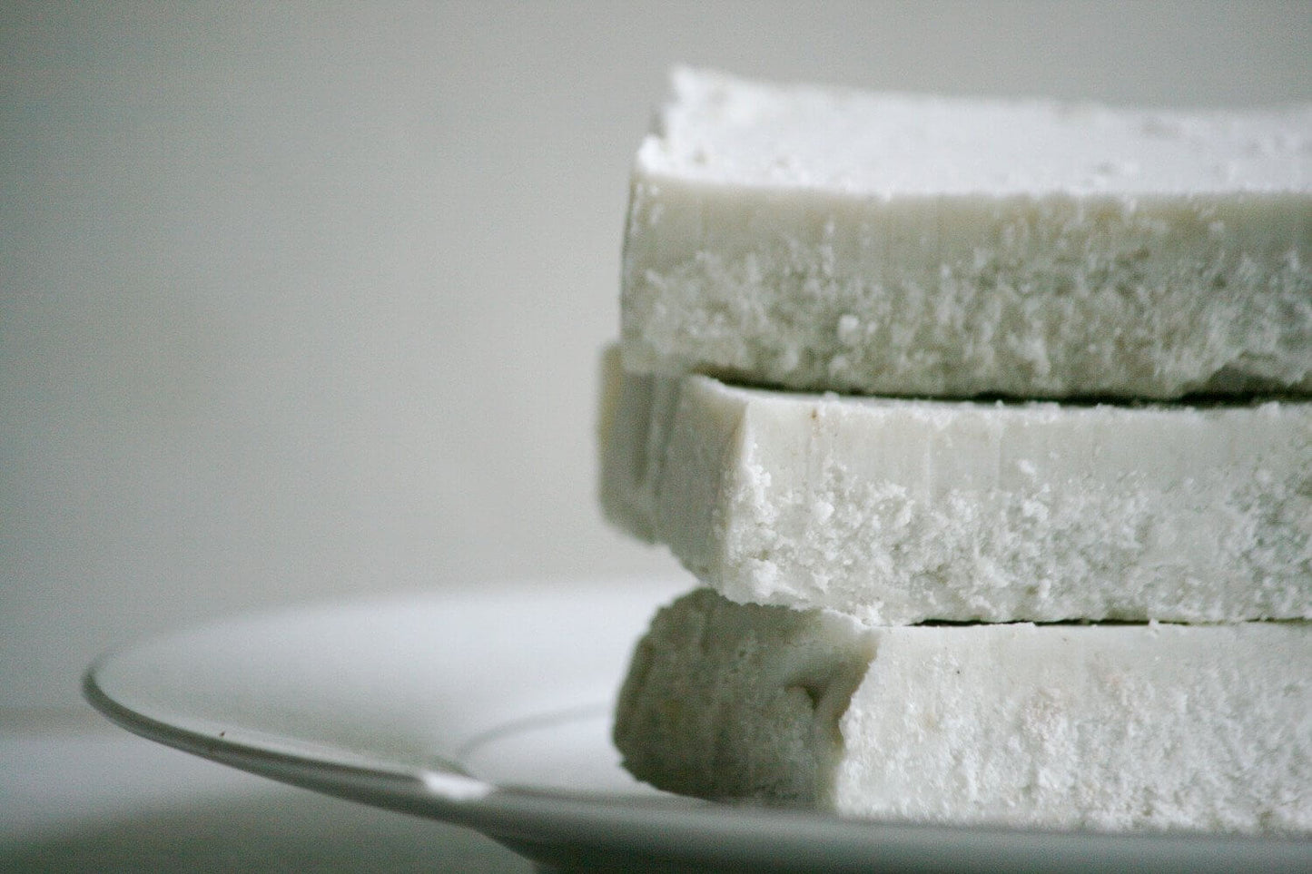 Stack of Lavender Mint Splash Sea Salt Bars on a white plate, showcasing a spa-quality experience for daily showers.