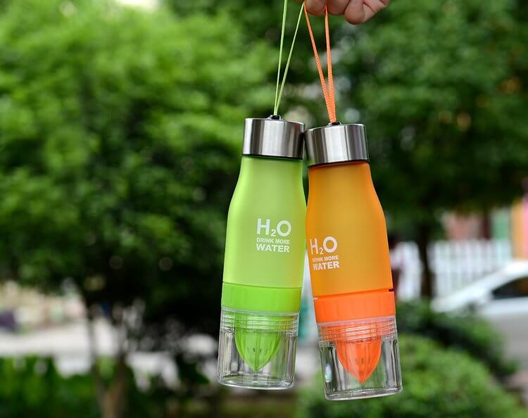 Lemon Fruit Juicer Bottles in green and orange, showcasing removable citrus press and hand grips.