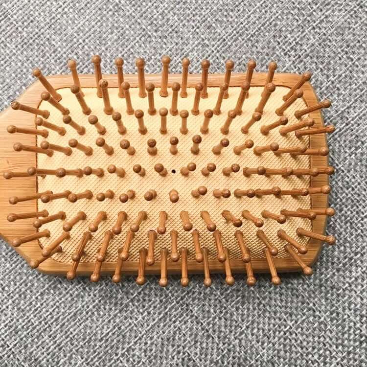 Natural bamboo hair brush with eco-friendly bristles, perfect for detangling and reducing hair static.