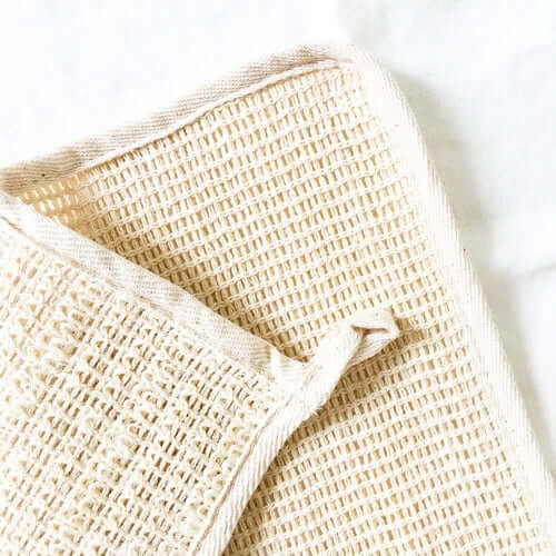 Close-up of a natural sisal washcloth, highlighting its soft, exfoliating texture and organic, sustainable design.