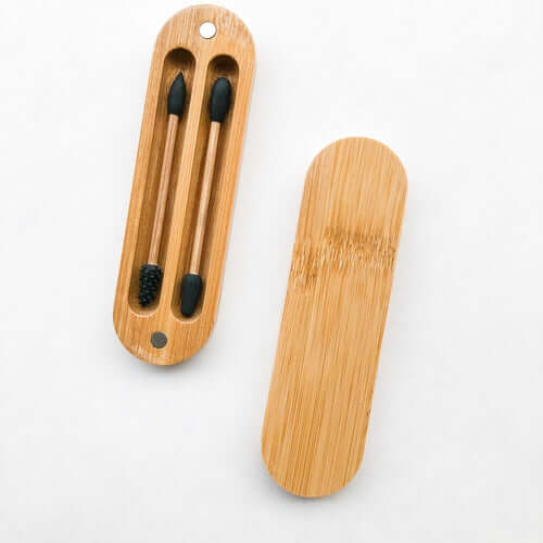 Reusable bamboo case holding eco-friendly silicone Q-tips for sustainable hygiene.