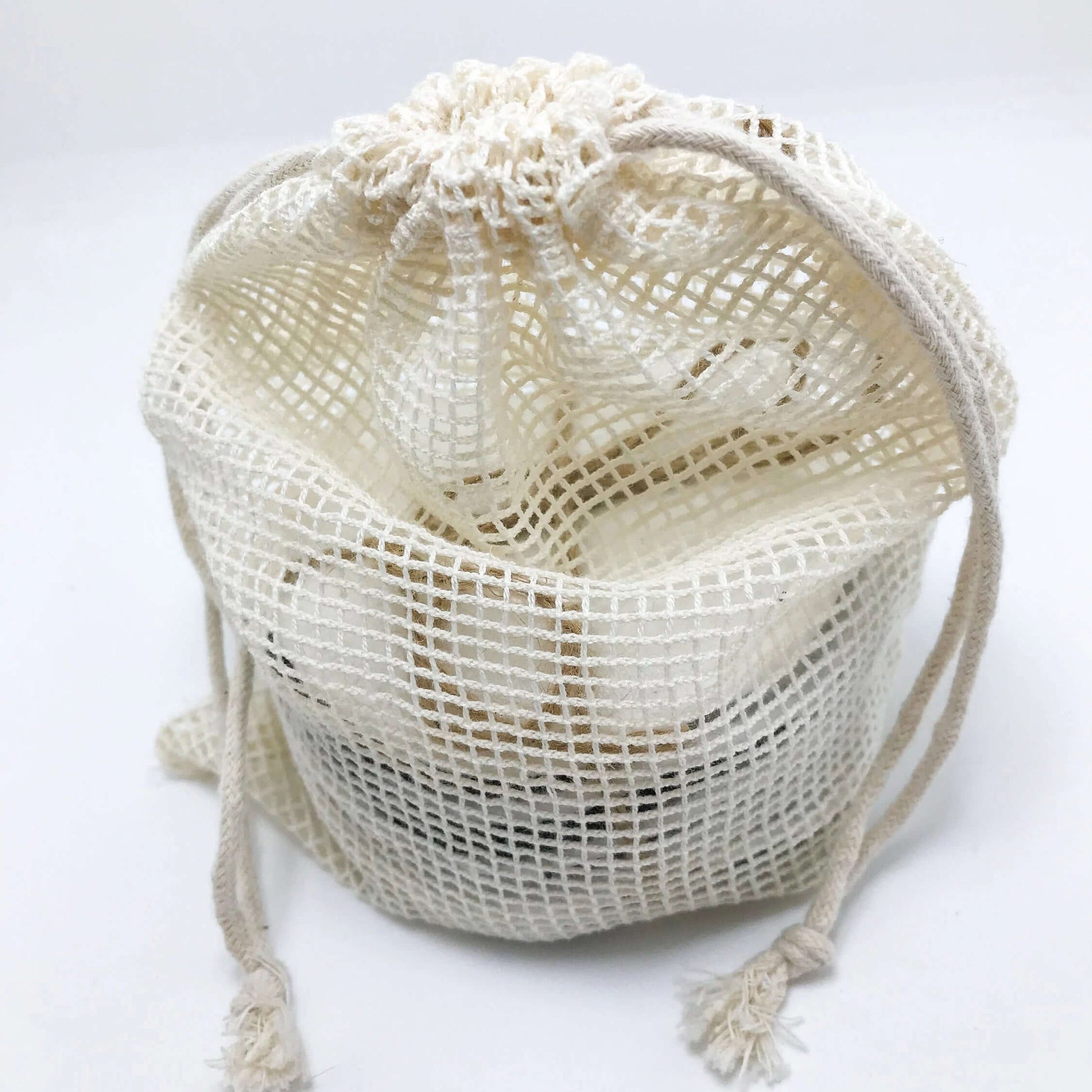 Eco-friendly mesh bag for storing reusable bamboo cotton facial pads, perfect for a zero-waste lifestyle.