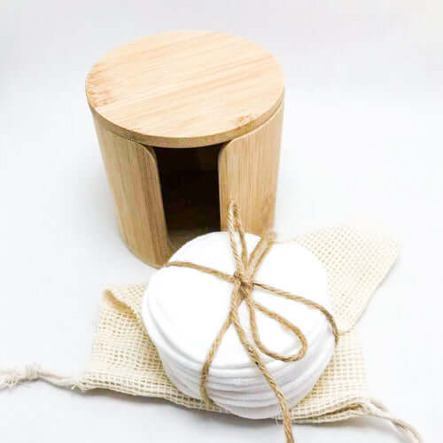 Eco-friendly bamboo container with reusable organic cotton facial pads for zero waste skincare.
