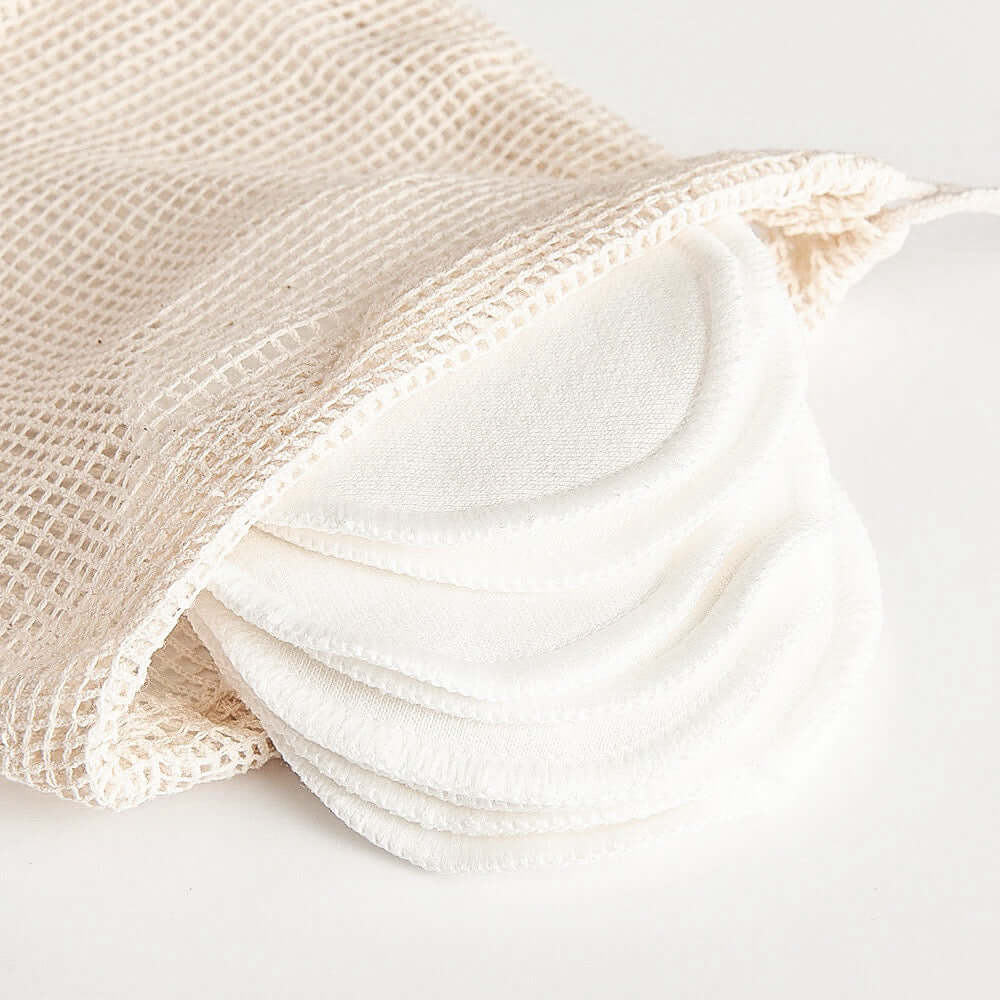 Organic bamboo cotton facial pads in a mesh bag, perfect for zero-waste skincare and eco-friendly makeup removal.
