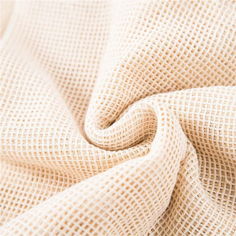 Close-up of a soft, breathable organic cotton mesh fabric, ideal for reusable produce bags and eco-friendly shopping.