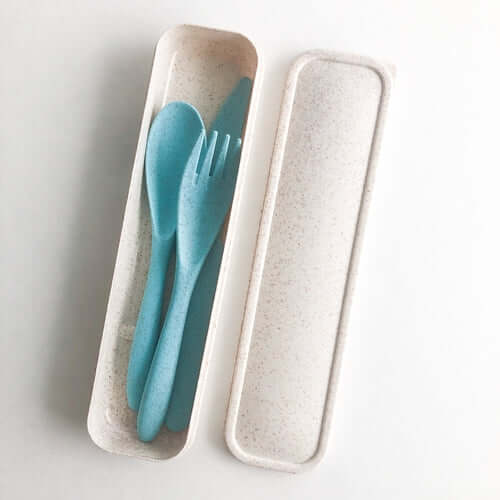 Reusable wheat straw cutlery set with blue utensils in a eco-friendly container, perfect for reducing single-use plastics.