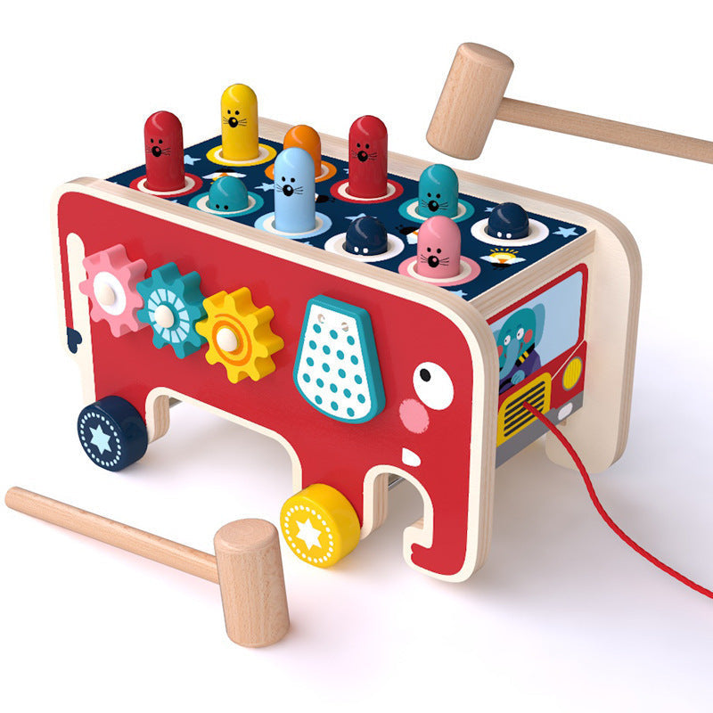 Colorful wooden pounding bench toy shaped like a bus, featuring adorable animal pegs and mallets for toddlers' play.