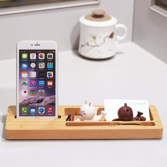 Bamboo desktop organizer holding a smartphone, cute figurines, and business cards for a stylish and eco-friendly workspace.