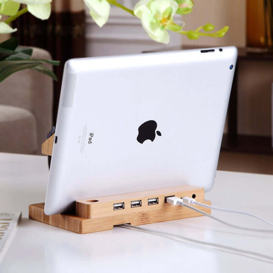 Handcrafted bamboo docking station with 4 USB ports, stylishly holding an iPad for organized charging.