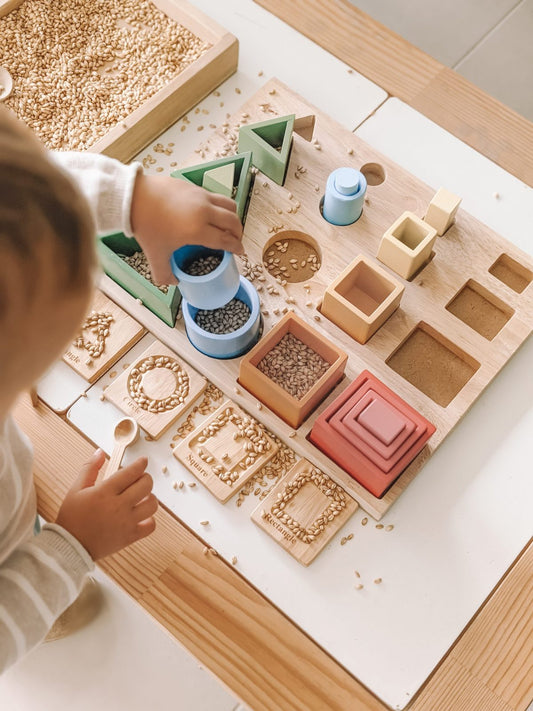 Toddler engaging with 3D Sorting and Nesting Board, stacking and sorting colorful wooden shapes for skill development.