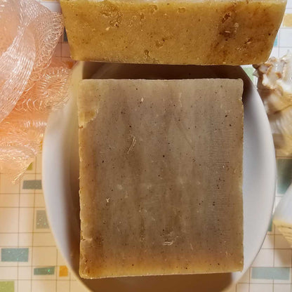 Amber Musk Handmade Soap in earthy tones, showcasing natural colors from Parsley and Turmeric, on a plate.