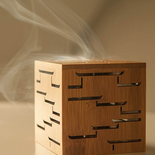 Elegant bamboo incense burner with smoke, showcasing intricate Chinese carvings for a serene aromatherapy experience.