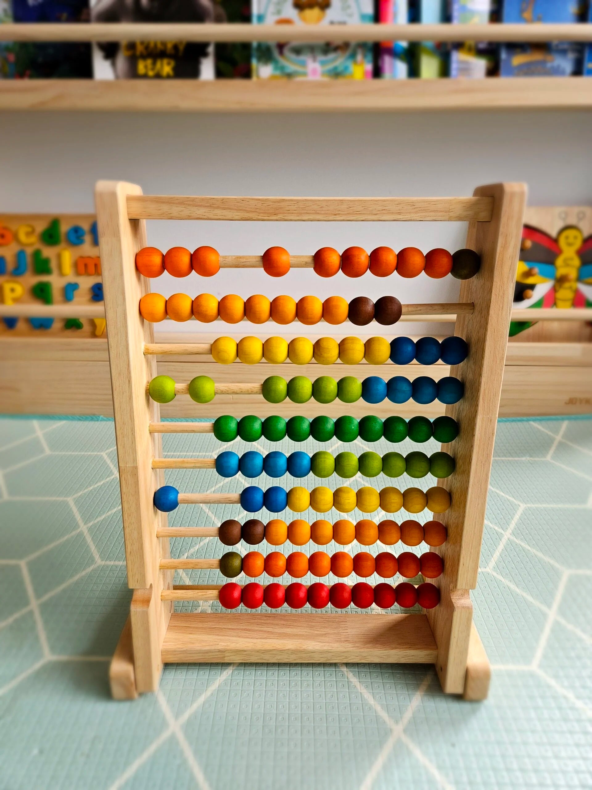 Colorful wooden bead counting abacus for toddlers, supports learning counting and math skills, interactive design.