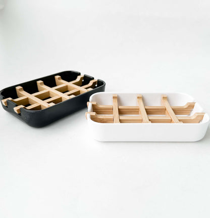 Biodegradable bamboo and cornstarch soap dishes in black and white, eco-friendly and plastic-free design for zero waste.