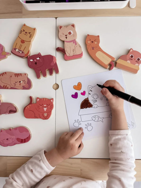 Child coloring with wooden cat toys from the Cat Play Set, fostering creativity and imagination.