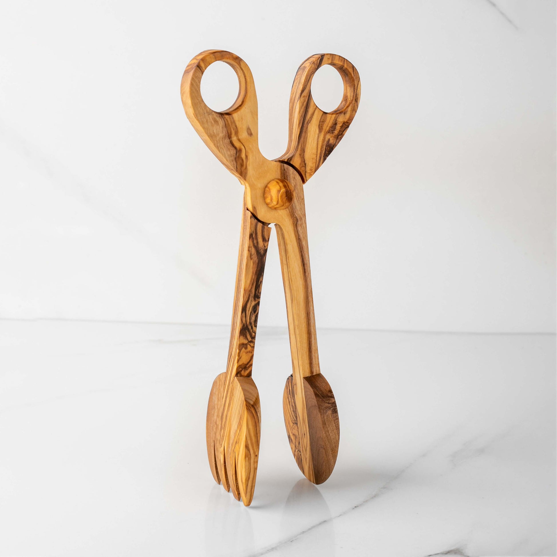 Handmade olive wood salad tongs with a unique design, offering elegance and eco-friendly serving solutions.