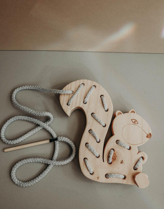 Handmade wooden squirrel lacing toy for kids, featuring cotton cord to enhance fine motor skills and hand-eye coordination.