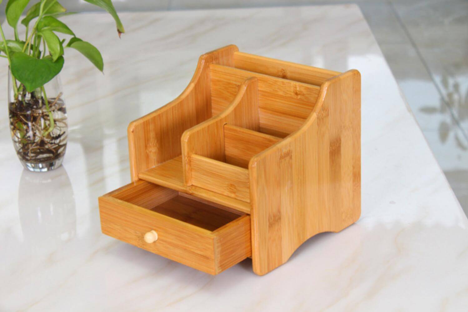Bamboo storage box with multiple compartments and a drawer, ideal for eco-friendly organization at home or office.