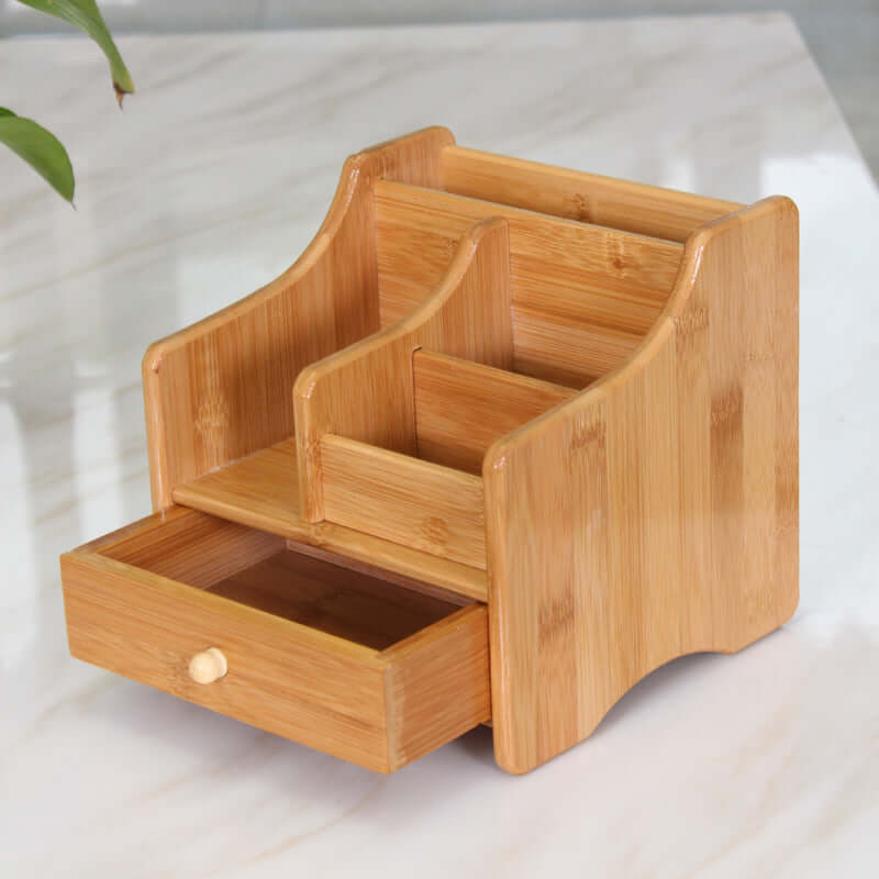Eco-friendly bamboo storage box organizer with multiple compartments and a drawer, ideal for home or office use.