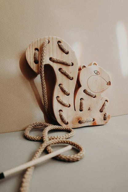 Wooden squirrel lacing toy, handmade from pinewood with cotton cord for Montessori pre-writing skills.