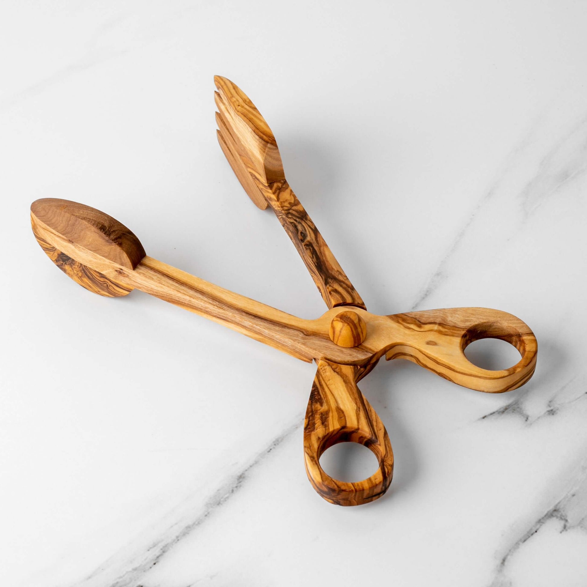 Handmade olive wood salad tongs featuring a comfortable grip and elegant design, perfect for eco-conscious dining.