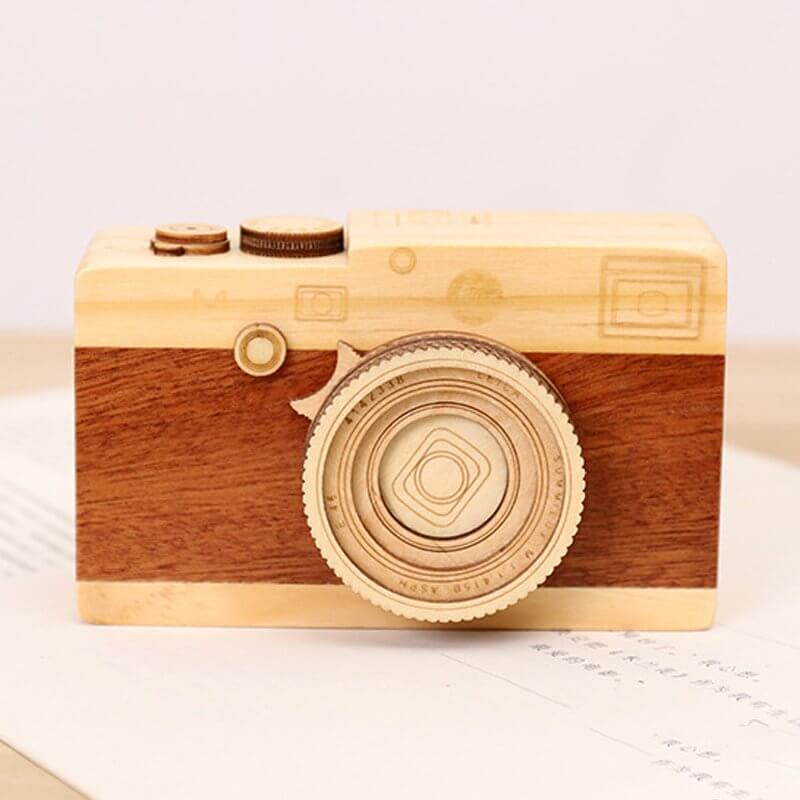 Wood camera music box featuring intricate craftsmanship and a charming design, playing 'City in the Sky'.
