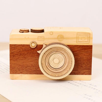 Wood camera music box featuring intricate craftsmanship and a charming design, playing 'City in the Sky'.