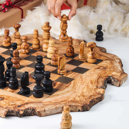 Handcrafted olive wood chess set with unique grain patterns and rustic bark edges, ideal for game nights and home decor.