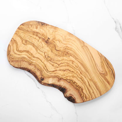 Handmade olive wood cutting board featuring unique natural edges and beautiful grain patterns.