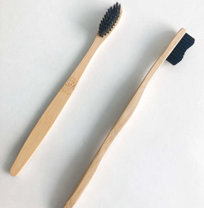 Eco-friendly bamboo toothbrushes with activated charcoal bristles for a sustainable and bright smile.