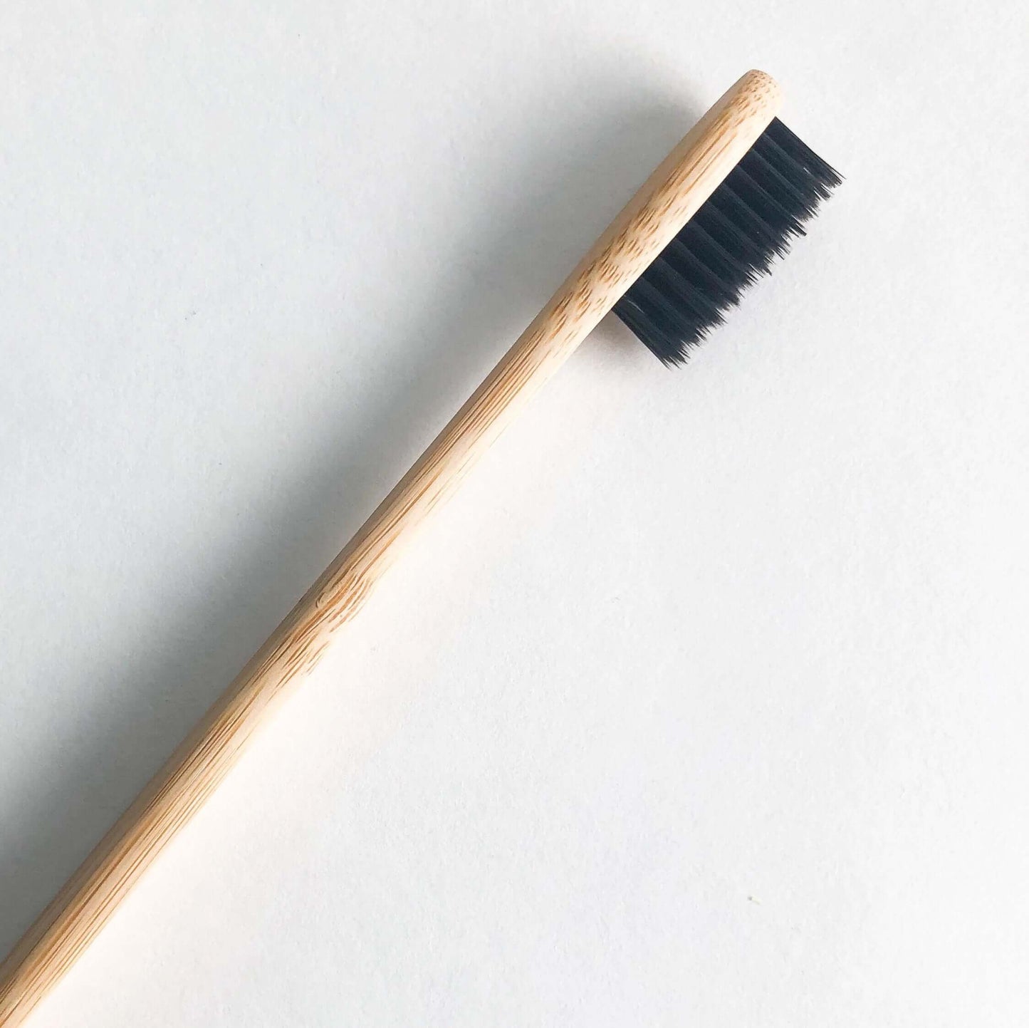 Eco-friendly bamboo toothbrush with activated charcoal bristles for a brighter smile and reduced plastic waste.