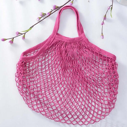 Reusable pink organic cotton mesh bag, perfect for grocery shopping and eco-friendly produce storage.