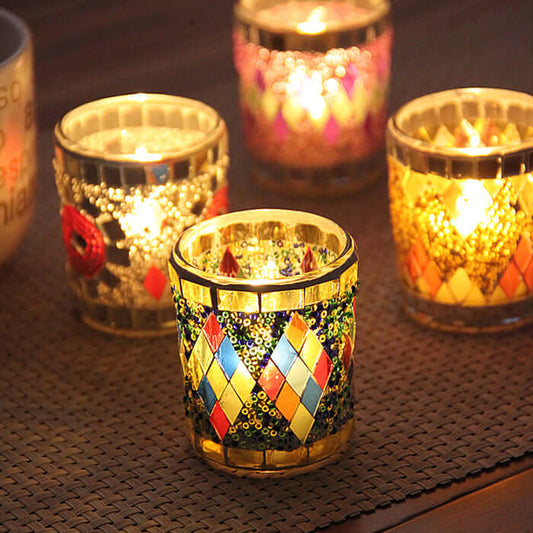 Colorful handmade glass candle holders with tealight candles, perfect for home décor and gifting.