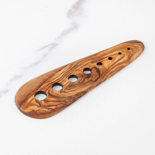 Handmade olive wood herb stripper with 5 holes for easy leaf removal from fresh herbs.