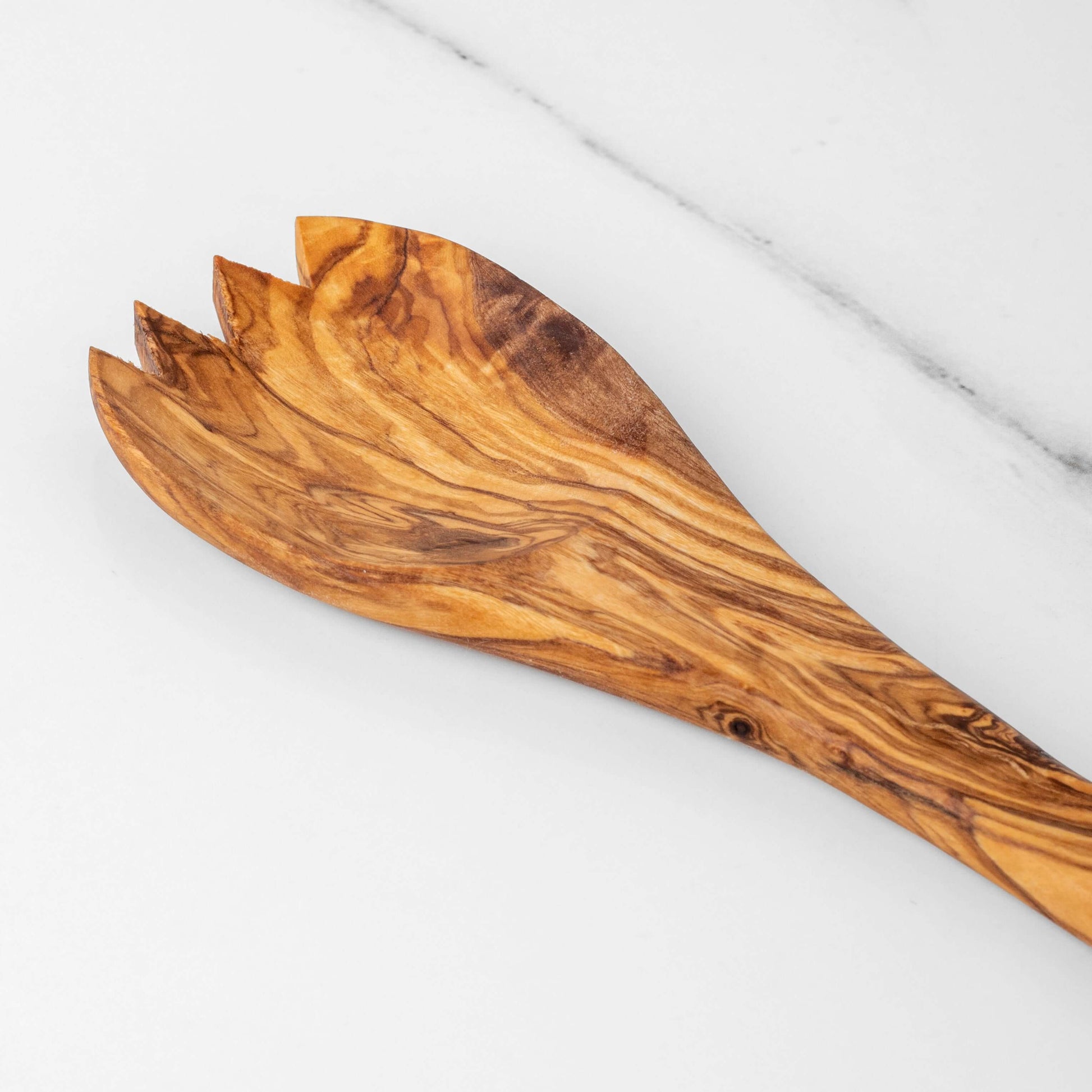 Handmade olive wood salad spork, 11.8 inches, eco-friendly, stylish, natural grain pattern on marble surface.