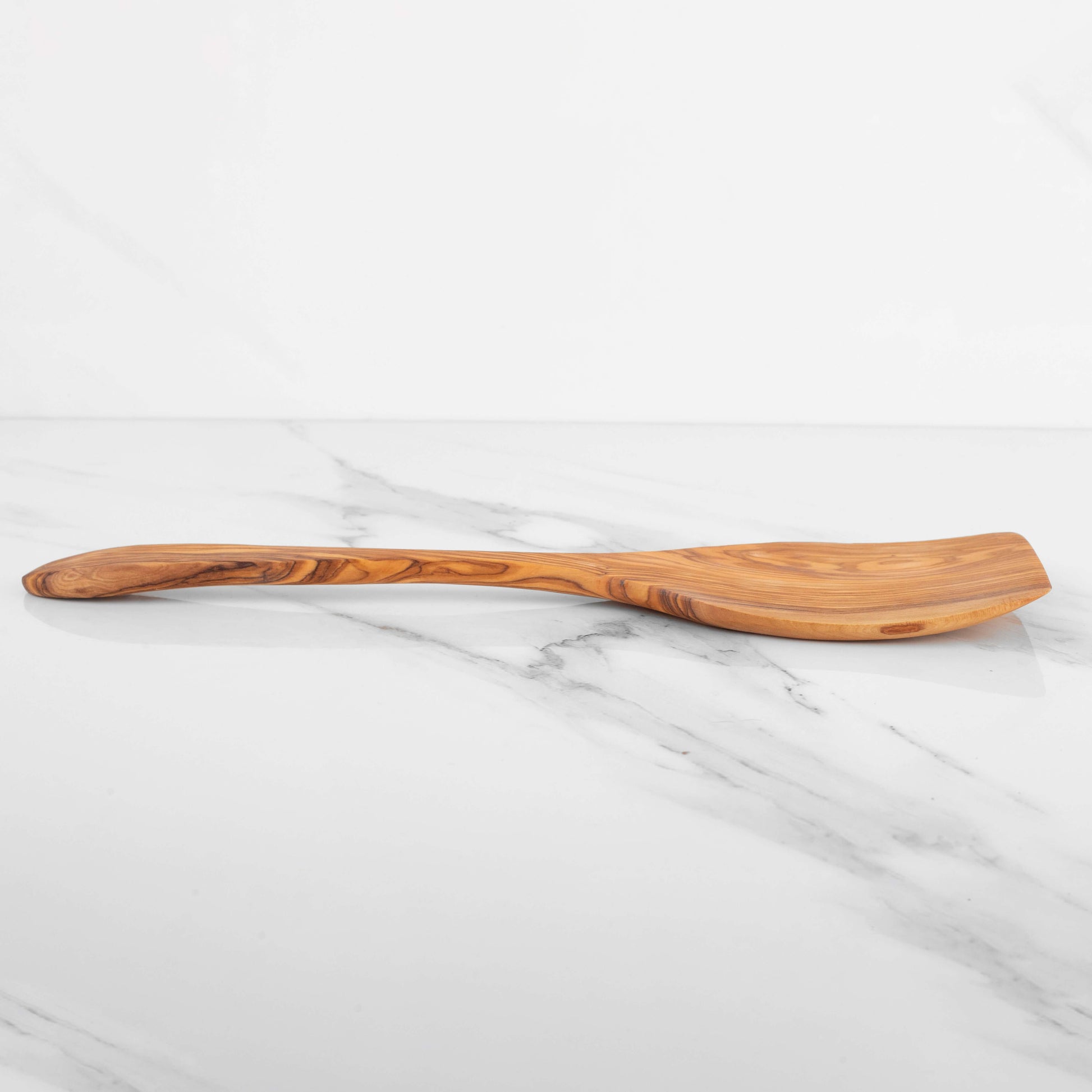 Handmade olive wood shovel spoon with wide flat surface, measuring 15.75 inches, perfect for cooking and serving.
