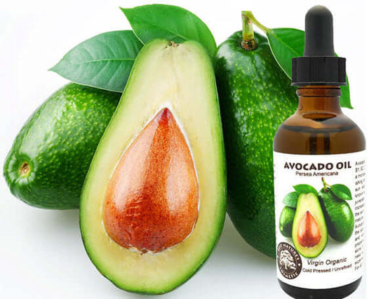 Organic virgin avocado oil bottle next to sliced avocado, highlighting its nourishing properties for skin care.